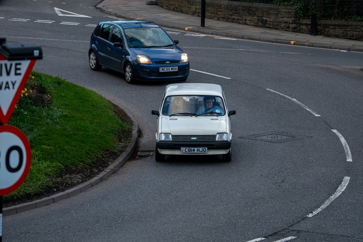 Cars approaching a give way junction on a UK road