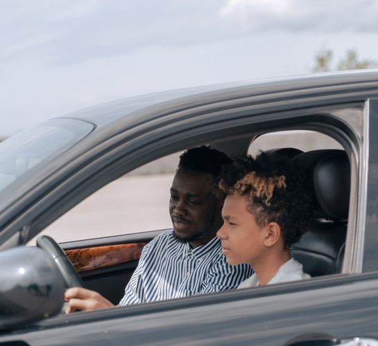 Driving instructor teaching a young learner