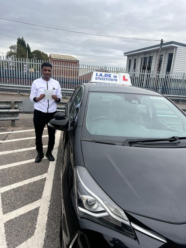 Driving school student holding their driving test pass certificate